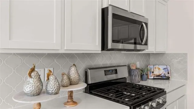 a kitchen with a stove and cabinets