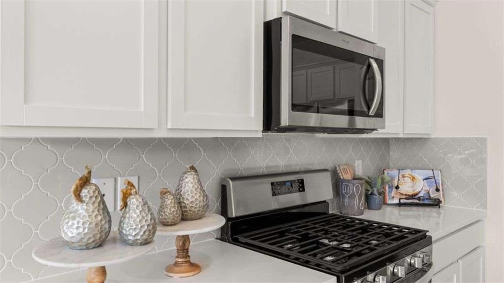 96 White Spruce Way Newnan, GA 30265 - Photo 5 of 43 a kitchen with a stove and cabinets