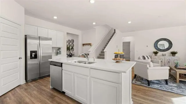 a kitchen with a sink appliances and cabinets
