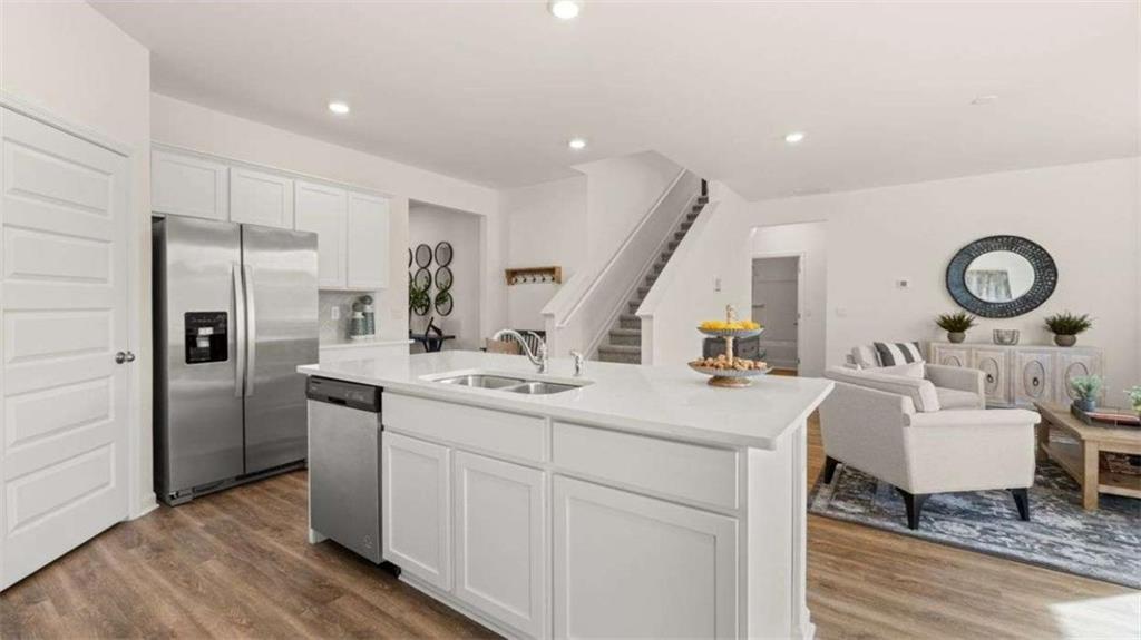 96 White Spruce Way Newnan, GA 30265 - Photo 6 of 43 a kitchen with a sink appliances and cabinets