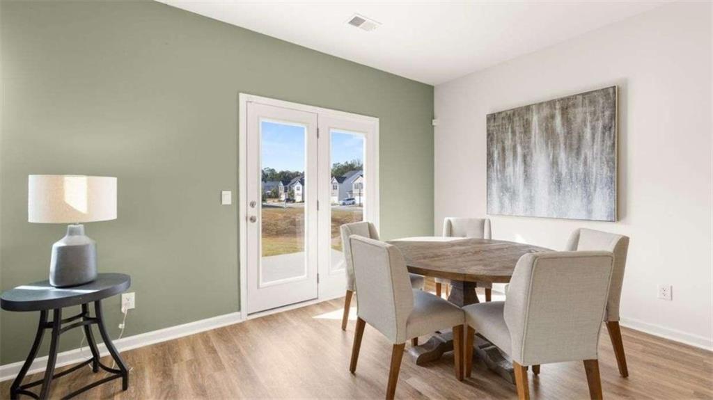 96 White Spruce Way Newnan, GA 30265 - Photo 7 of 43 a view of a dining room with furniture window and wooden floor