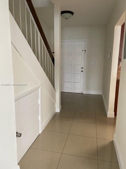 5631 West 28th Avenue, Unit 1 Hialeah, FL 33016 - Photo 17 of 18 a view of entryway with stairs and wooden floor