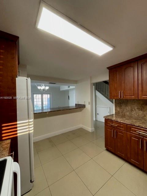 5631 West 28th Avenue, Unit 1 Hialeah, FL 33016 - Photo 5 of 18 a kitchen with stainless steel appliances granite countertop a stove and a sink