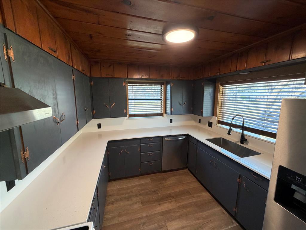 1605 South Houston Street Kaufman, TX 75142 - Photo 16 of 27 a large kitchen with stainless steel appliances a large counter top