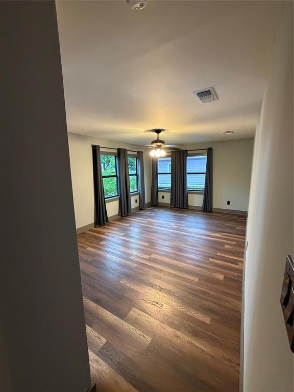 1605 South Houston Street Kaufman, TX 75142 - Photo 18 of 27 wooden floor in an empty room with a window