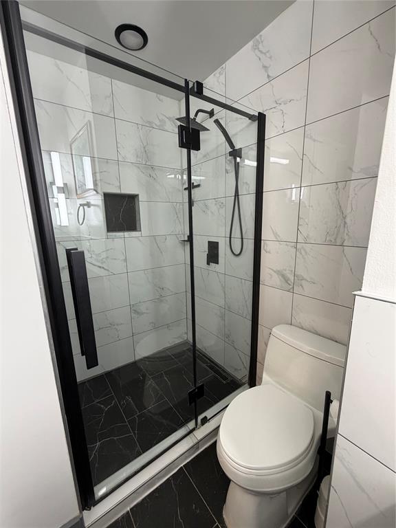 1605 South Houston Street Kaufman, TX 75142 - Photo 19 of 27 a bathroom with a shower and toilet