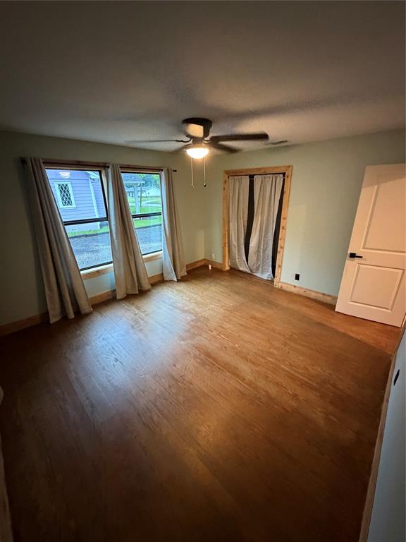 1605 South Houston Street Kaufman, TX 75142 - Photo 21 of 27 a view of an empty room with a window and wooden floor