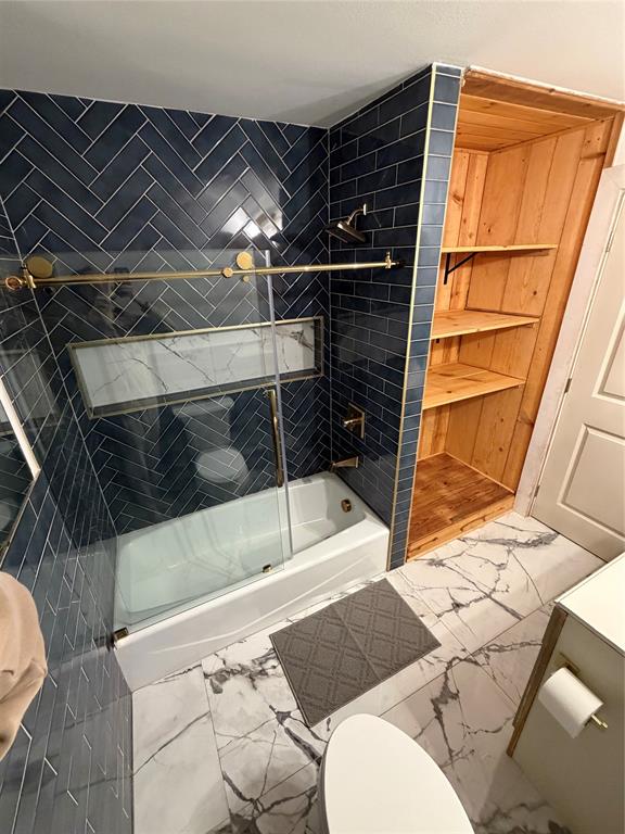 1605 South Houston Street Kaufman, TX 75142 - Photo 23 of 27 a bathroom with a toilet and a shower