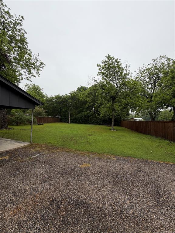 1605 South Houston Street Kaufman, TX 75142 - Photo 9 of 27 a view of a field of grass and trees