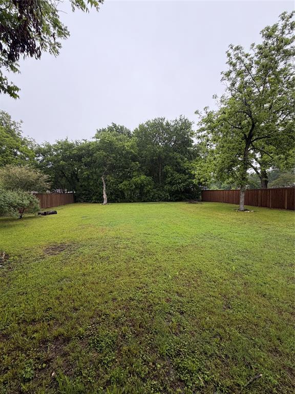 1605 South Houston Street Kaufman, TX 75142 - Photo 10 of 27 a view of a field with an trees in the background