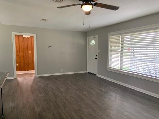 1000 Thomas Avenue Conroe, TX 77301 - Photo 16 of 20 an empty room with wooden floor fan and windows