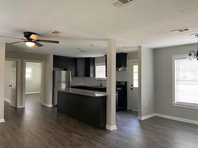 1000 Thomas Avenue Conroe, TX 77301 - Photo 2 of 20 an open kitchen with stainless steel appliances granite countertop a refrigerator and a stove top oven