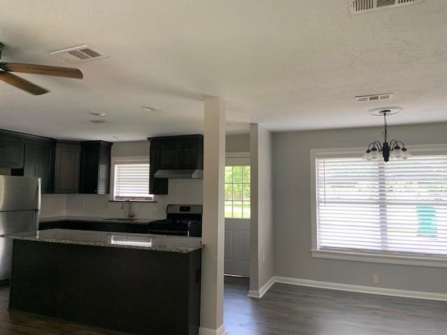 1000 Thomas Avenue Conroe, TX 77301 - Photo 3 of 20 a kitchen with kitchen island a sink stainless steel appliances and cabinets