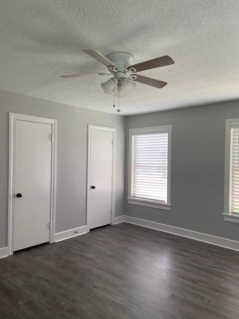 1000 Thomas Avenue Conroe, TX 77301 - Photo 6 of 20 an empty room with wooden floor ceiling fan and windows