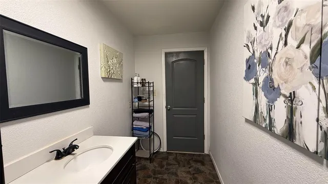 a bedroom with a bed a mirror and a window