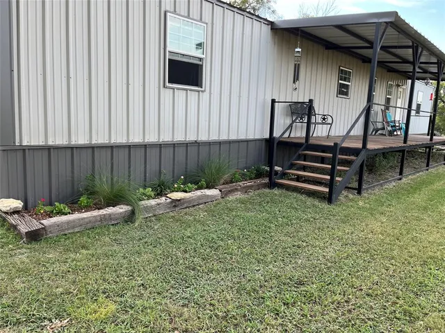 a view of a backyard with sitting area