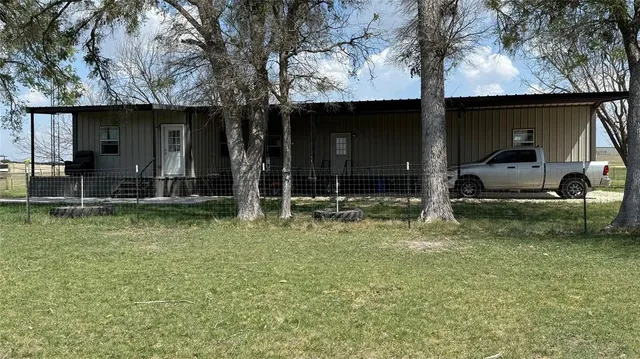 a house view with a swimming pool table and chairs