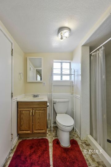1639 Sims Street Ridgecrest, CA 93555 - Photo 34 of 38 a bathroom with a toilet and a sink