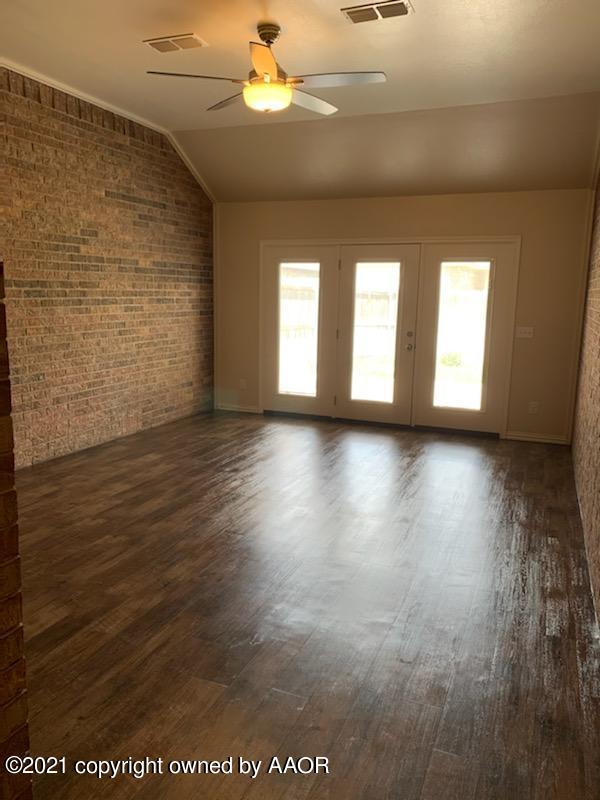 5803 South Rusk Street Amarillo, TX 79118 - Photo 8 of 23 an empty room with wooden floor and windows