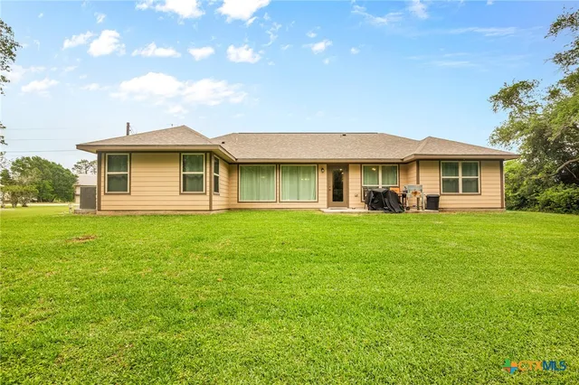 a front view of house with yard and green space
