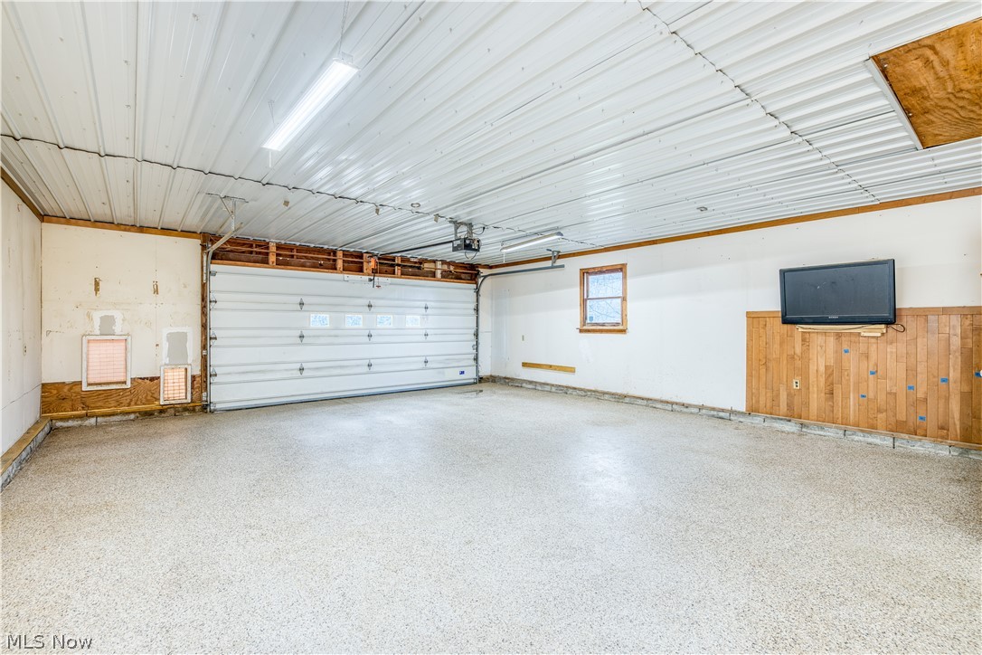 8750 Whitaker Road Cambridge, OH 43725 - Photo 23 of 29 Garage featuring a garage door opener