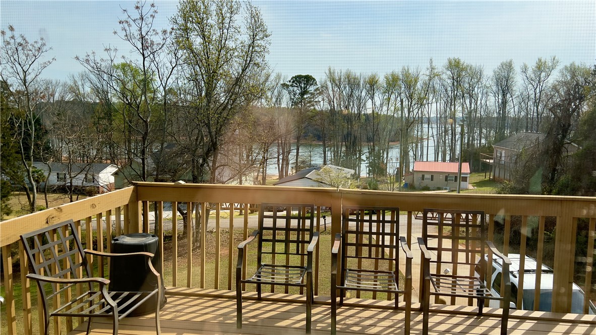 160 Hudgins Lake Road Townville, SC 29689 - Photo 30 of 41 A spacious deck overlooks tranquil water and lush surrounding trees.