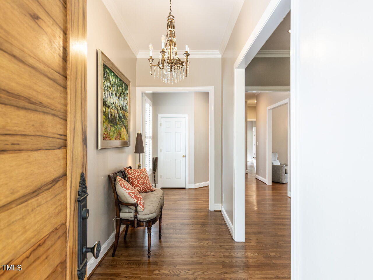 3108 Agecroft Road Raleigh, NC 27608 - Photo 13 of 42 a view of a hallway with furniture and a chandelier