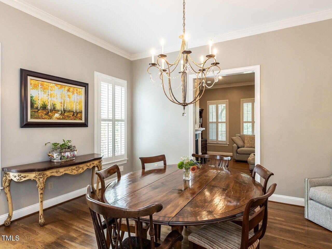 3108 Agecroft Road Raleigh, NC 27608 - Photo 16 of 42 a view of a dining room with furniture a chandelier and wooden floor
