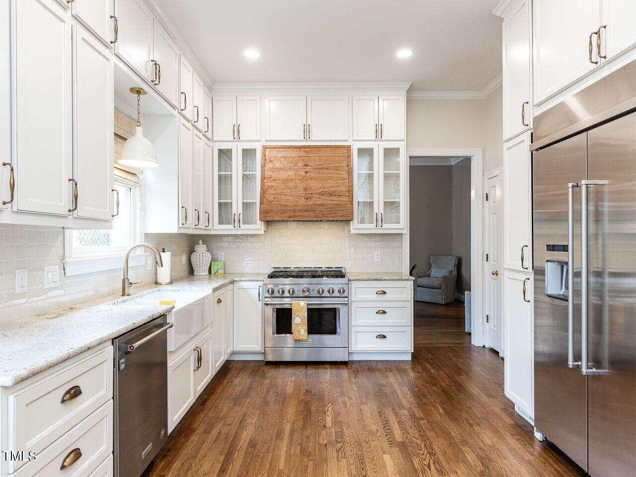 3108 Agecroft Road Raleigh, NC 27608 - Photo 3 of 42 a kitchen with stainless steel appliances a stove a sink and a refrigerator