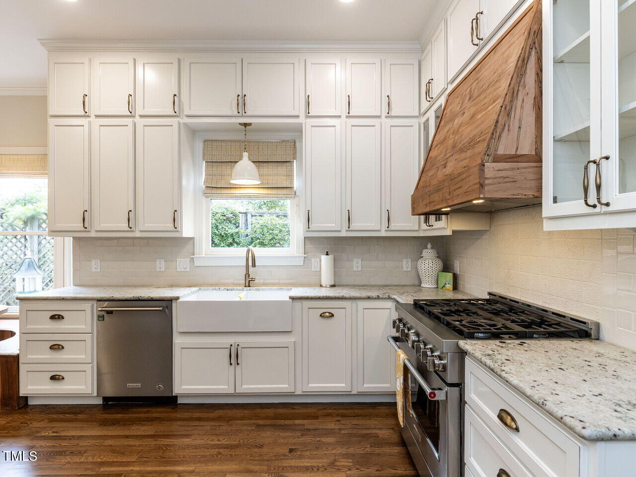 3108 Agecroft Road Raleigh, NC 27608 - Photo 4 of 42 a kitchen with stainless steel appliances granite countertop a sink a stove and a refrigerator