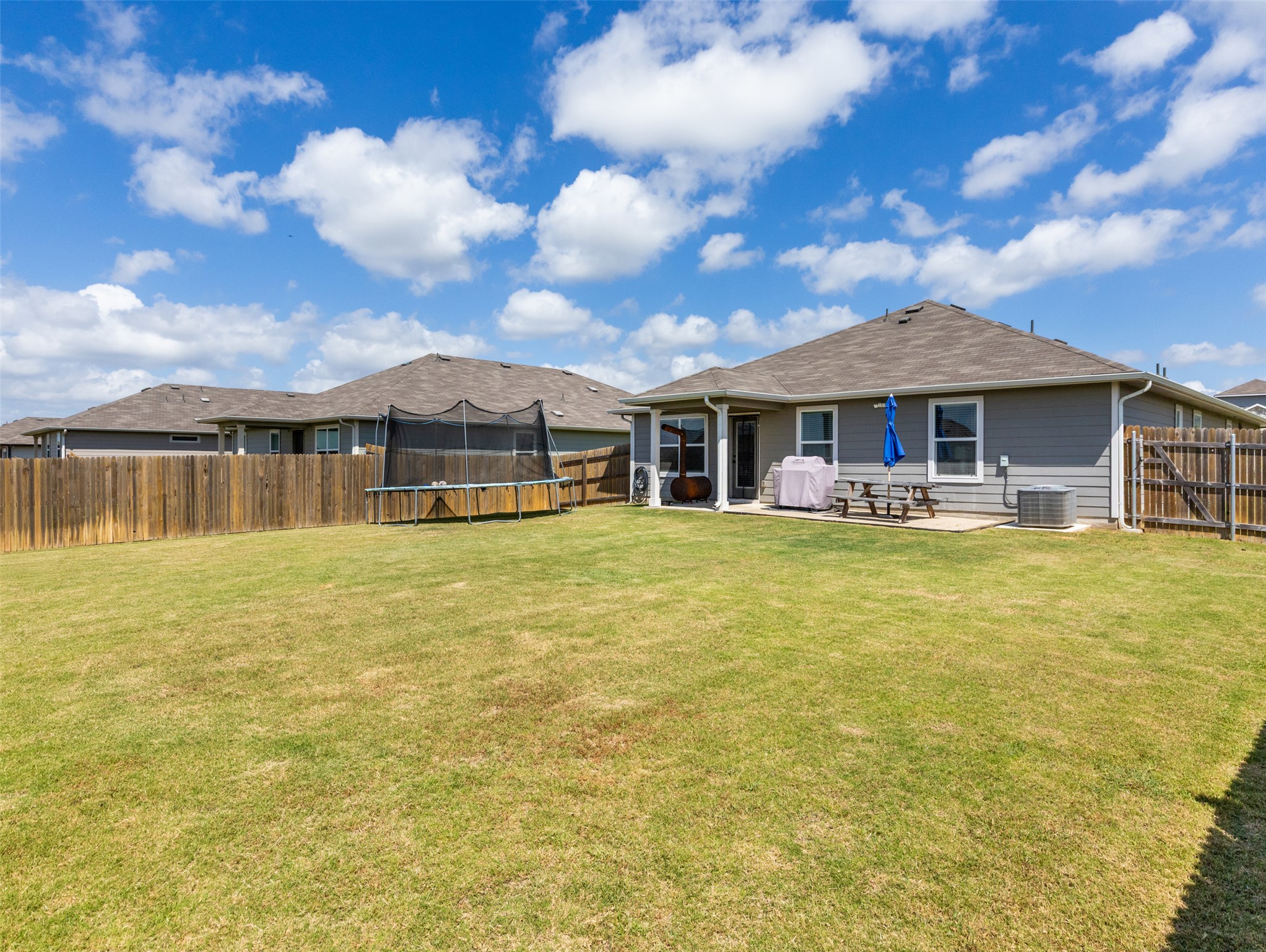 439 Hunter Loop Bertram, TX 78605 - Photo 23 of 23 A fenced backyard offers a patio for outdoor enjoyment, providing ample space for relaxation.