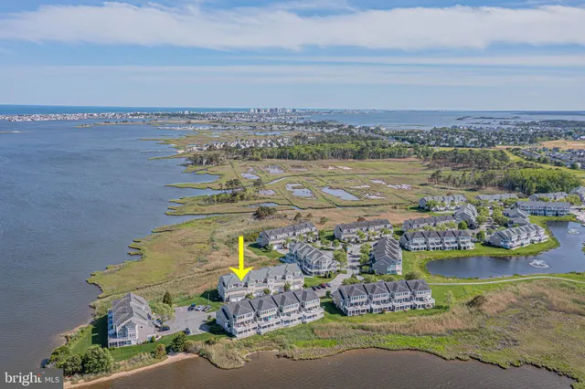 an aerial view of a house with a ocean view