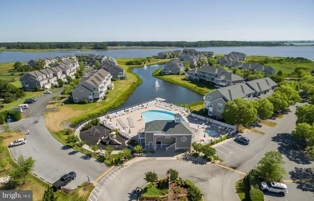 an aerial view of a house with a swimming pool patio and outdoor seating