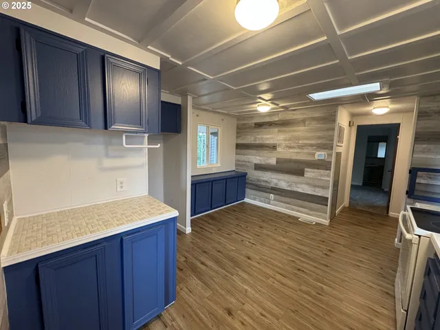 a view of kitchen with cabinets and wooden floor
