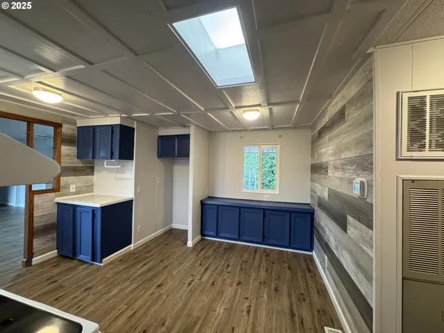 a kitchen with wooden floors and wooden cabinets