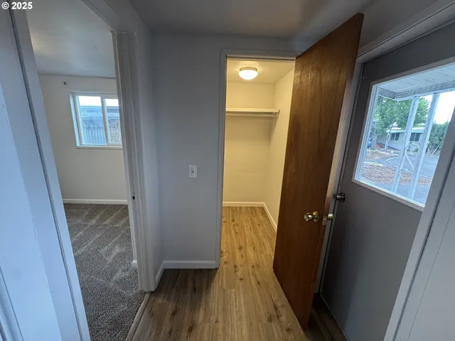 a view of hallway with wooden floor