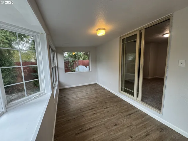 a view of wooden floor and windows in an empty room
