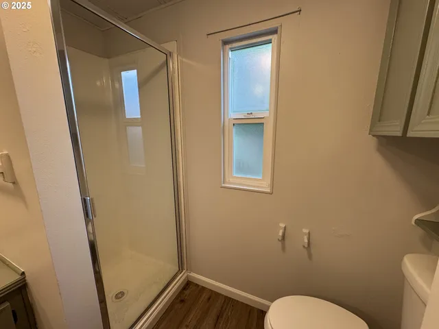 a bathroom with a toilet and a shower