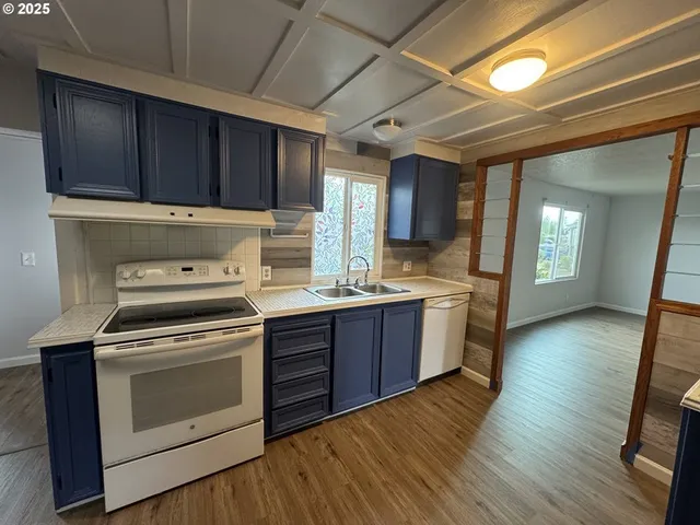 a kitchen with wooden floors and a sink