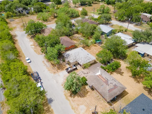 an aerial view of residential houses with outdoor space
