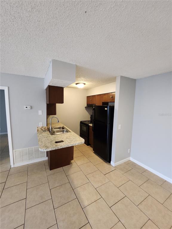 626 Golden Raintree Place, Unit 626 Brandon, FL 33510 - Photo 3 of 9 a view of kitchen with furniture and refrigerator