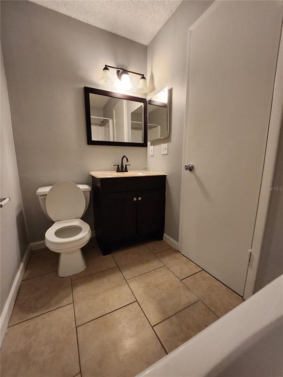 626 Golden Raintree Place, Unit 626 Brandon, FL 33510 - Photo 6 of 9 a bathroom with a toilet sink and mirror