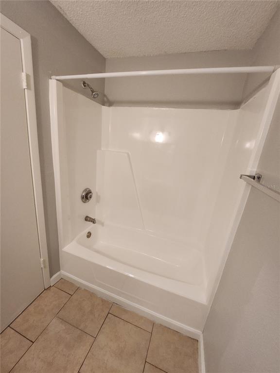 626 Golden Raintree Place, Unit 626 Brandon, FL 33510 - Photo 7 of 9 a bathroom with a shower and a bath tub