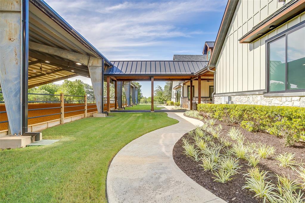 5000 T W King Road Southlake, TX 76092 - Photo 26 of 40 Covered walkway from arena to barn ensures dry, comfortable access between sessions in any weather.