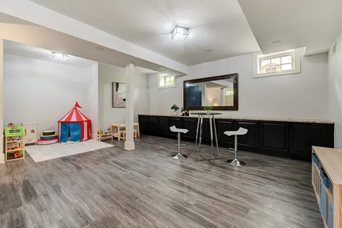 a view of a workspace with wooden floor and a workspace