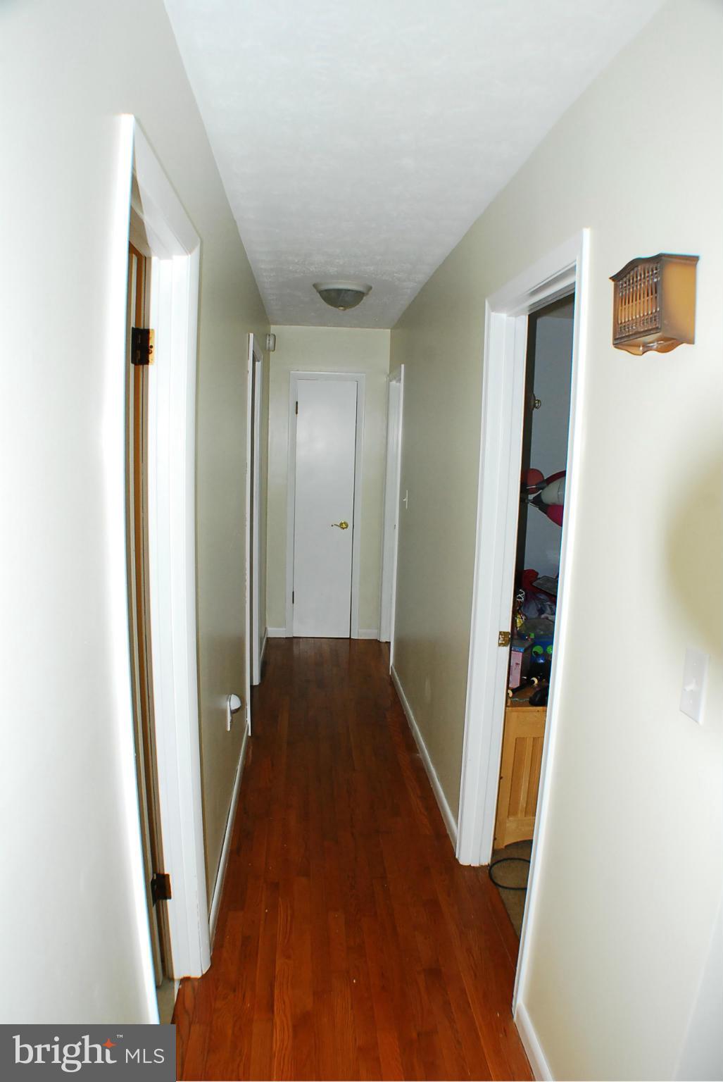 155 Fries Loop Road White Post, VA 22663 - Photo 15 of 29 a view of a hallway with wooden floor and staircase