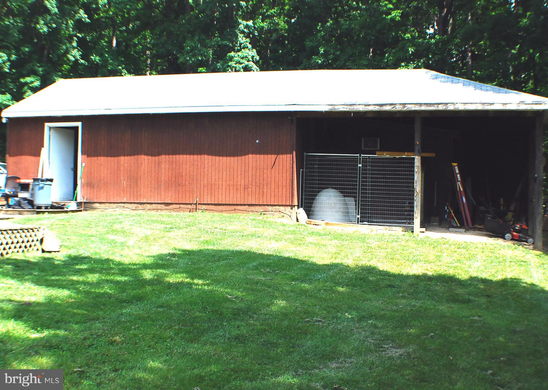155 Fries Loop Road White Post, VA 22663 - Photo 7 of 29 a front view of a house with a yard and garage