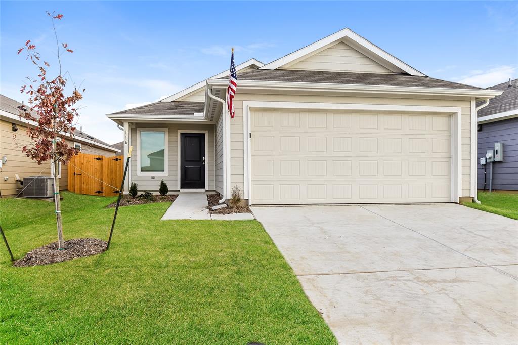 a view of a house with a small yard and plants
