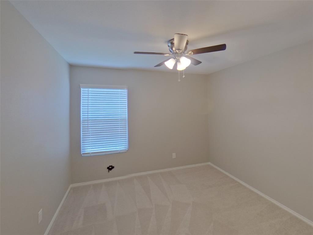116 Cornstalk Lane Princeton, TX 75407 - Photo 11 of 17 an empty room with a window and a fan