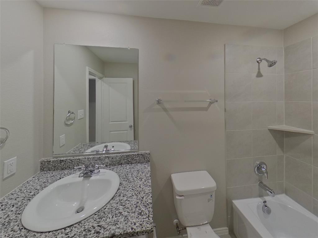 116 Cornstalk Lane Princeton, TX 75407 - Photo 14 of 17 a bathroom with a granite countertop sink and a mirror